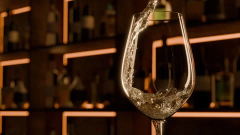 Friday evening in cozy bar. Close up shot of white wine pouring into glass Video stock 295212569