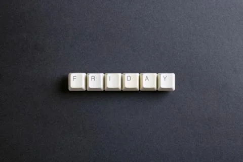 Friday word on computer keys button on a dark background. Stock Photos
