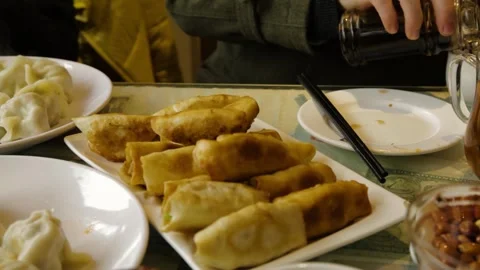 Fried and Steamed Dumplings Served at Table with Tea in Beijing Restaurant Stock Footage 345745260