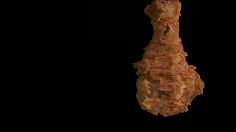 Fried, appetizing chicken leg rotates on a black background. Stock Footage 125830626