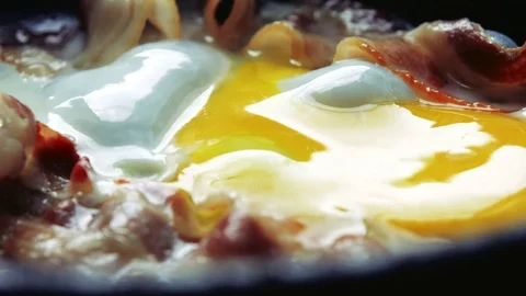 Fried bacon and Eggs. Stock-Footage 77613992