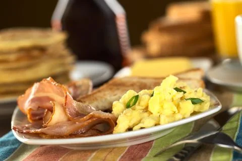 Fried bacon and scrambled egg Stock Photos