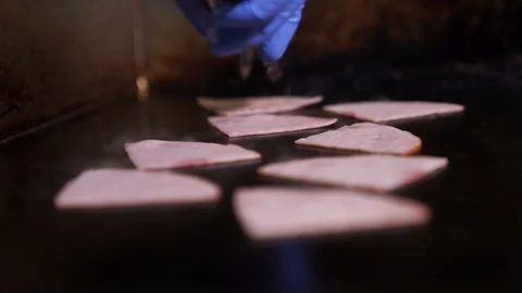 Fried bacon on griddle Stock Footage 127749767