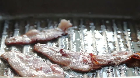 Fried bacon in hot pan. Stock Footage 54210787