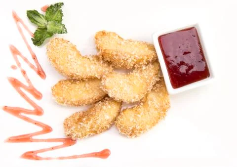 Fried banana with raspberry jam on a white background with mint Stock Photos