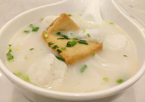 Fried bean curd and fish ball in the white soup Stock Photos