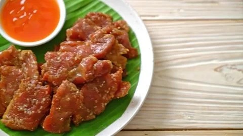 Fried beef chunks with spicy dipping sauce on a white plate Stock Photos