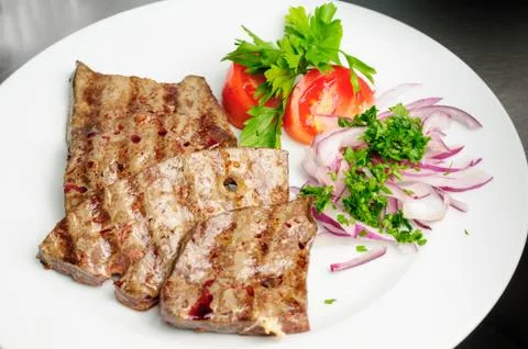 Fried beef liver with vegetables Stock Photos