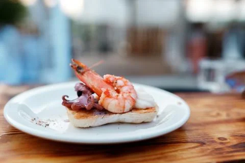 Fried big shrimp on White bread ciabatta toasted on an outdoor grill Stock Photos
