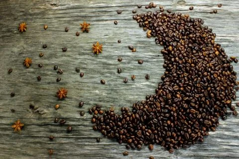 Fried black coffee beans, located in the shape of the moon, and anise like st Stock Photos