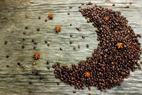 Fried black coffee beans, located in the shape of the moon, and anise like st Stock Photos