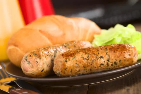 Fried bratwurst with bun Stock Photos