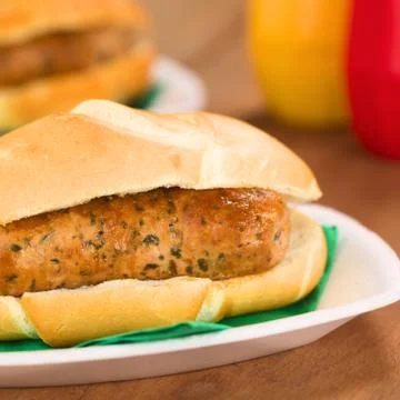 Fried bratwurst in bun Stock Photos