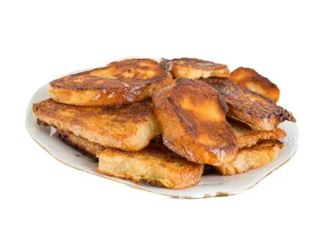 Fried bread in the milk on a plate Stock Photos