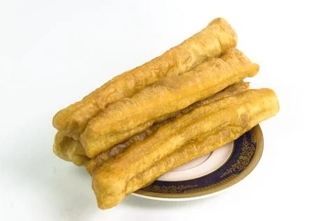 Fried bread or cakwe isolated on a white background. Also known as Youtiao .. Stock Photos