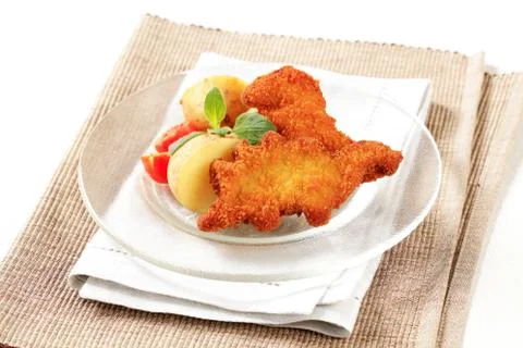 Fried breaded fish with potatoes Stock Photos