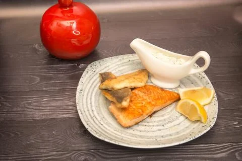 Fried breaded fish with white sauce and lemon Stock Photos