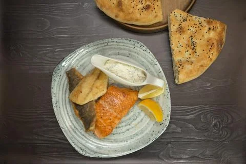 Fried breaded fish with white sauce and lemon Stock Photos