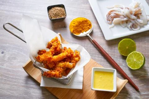 Fried breaded squid and curry sauce and lime Stock Photos