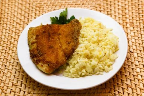 Fried breaded tilapia served with rice Stock Photos