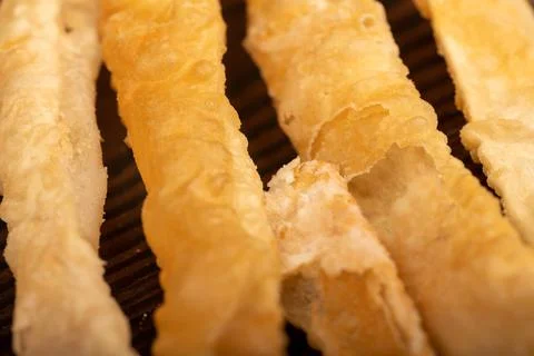 Fried breadsticks with salt, close-up, selective focus. Stock Photos