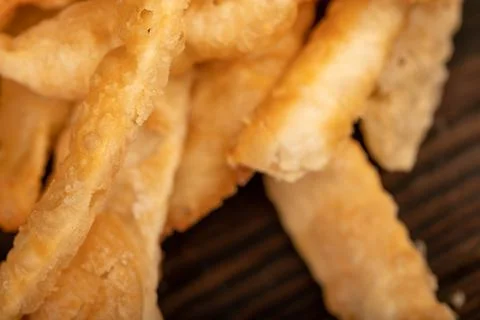 Fried breadsticks with salt, close-up, selective focus. Stock Photos