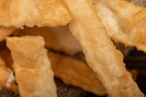 Fried breadsticks with salt, close-up, selective focus. Stock Photos