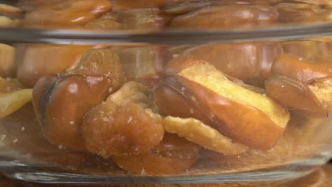 Fried broad bean rotating in glass bowl macro. Salty roasted broad bean beer Stock Footage 244813195