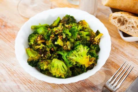 Fried broccoli with spices on a plate Stock Photos