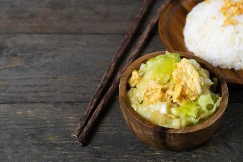 Fried cabbage and fried egg in oyster sauce, Rice in wooden dish. Stock Photos