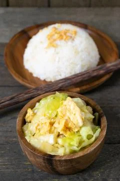 Fried cabbage and fried egg in oyster sauce, Rice in wooden dish. Stock Photos