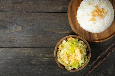 Fried cabbage and fried egg in oyster sauce, Rice in wooden dish. Stock Photos