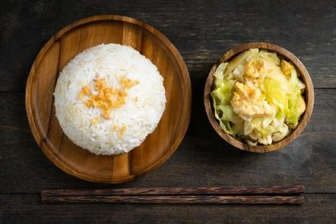 Fried cabbage and fried egg in oyster sauce, Rice in wooden dish. Stock Photos