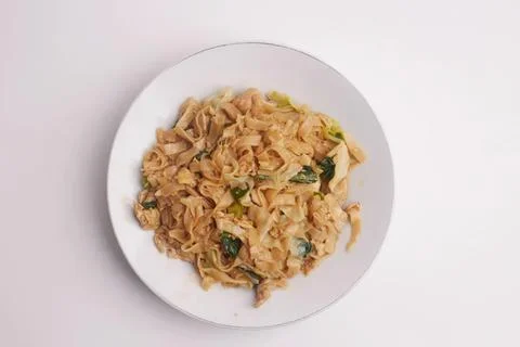 Fried cabbage and vegetable stir-fry on white plate Stock Photos