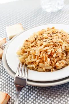 Fried cabbage with caraway and garlic on a plate Stock Photos