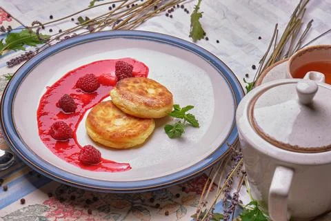 Fried cheese cakes pancake with raspberry jam and mint Stock Photos