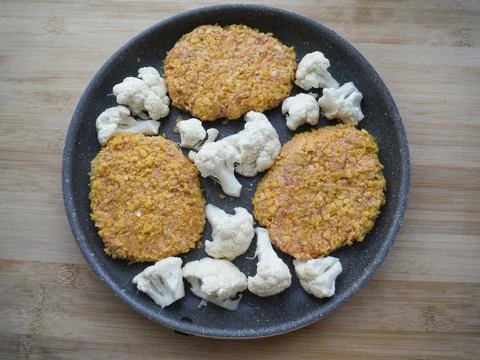 Fried chicken and turkey cutlets with cauliflower in a frying pan. Foto stock