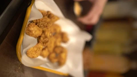 Fried chicken balls are cooked in the fryer and ready to serve Video stock 196142710