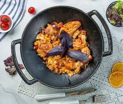 Fried chicken with basil in the pan Stock Photos