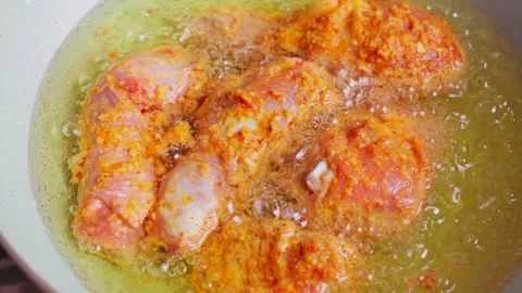 Fried chicken being cooked in hot oil Stock Footage 329836689