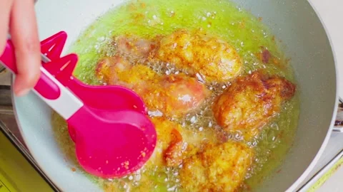 Fried chicken being cooked in hot oil 2 Stock Footage 329836893