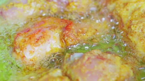 Fried chicken being cooked in hot oil 4 Stock Footage 329836902