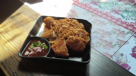 Fried chicken on a black plate on the dining table, Thai style Hat Yai Stock Footage 321986473