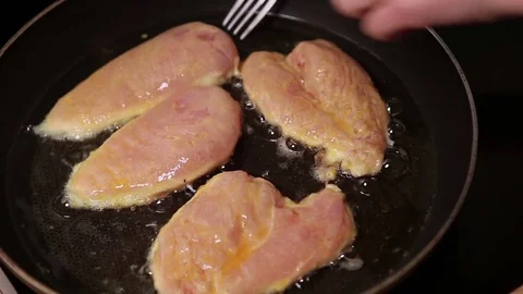 Fried chicken breast on a hot pan Stock Footage
