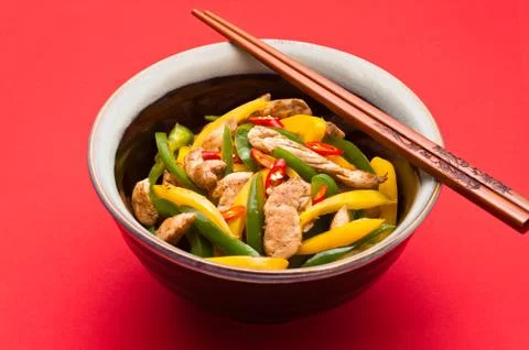 Fried chicken with capsicum on red table cloth Stock Photos