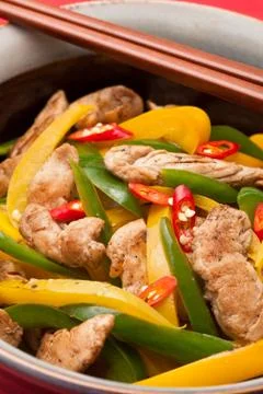 Fried chicken with capsicum on red table cloth Stock Photos
