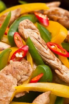 Fried chicken with capsicum on red table cloth Stock Photos