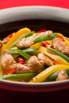 Fried chicken with capsicum on red table cloth Stock Photos