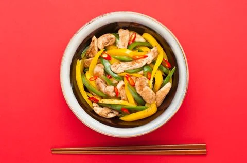 Fried chicken with capsicum on red table cloth Stock Photos