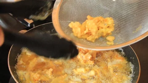 The fried chicken is cooked. someone drains fried chicken Stock Footage 334647605